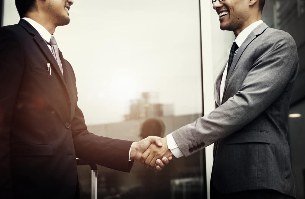 Corporate businessmen shaking hands IB Forex คือ